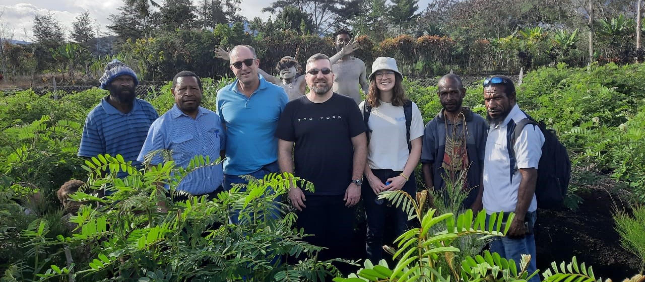Group of researchers in coffee field 