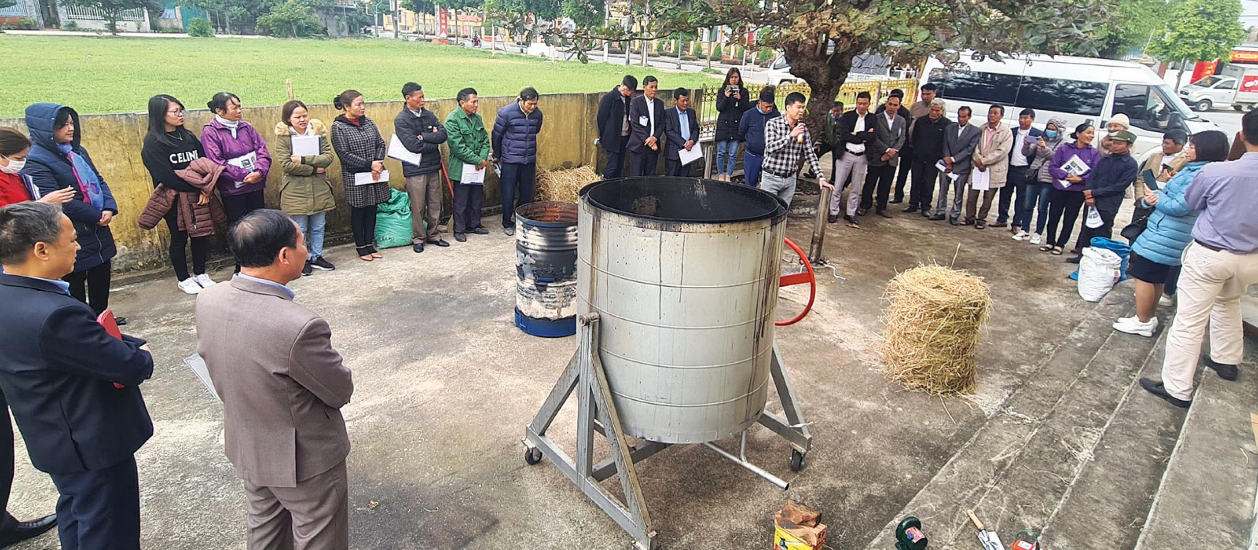 a large group of people standing on concrete surrounding a biochar.