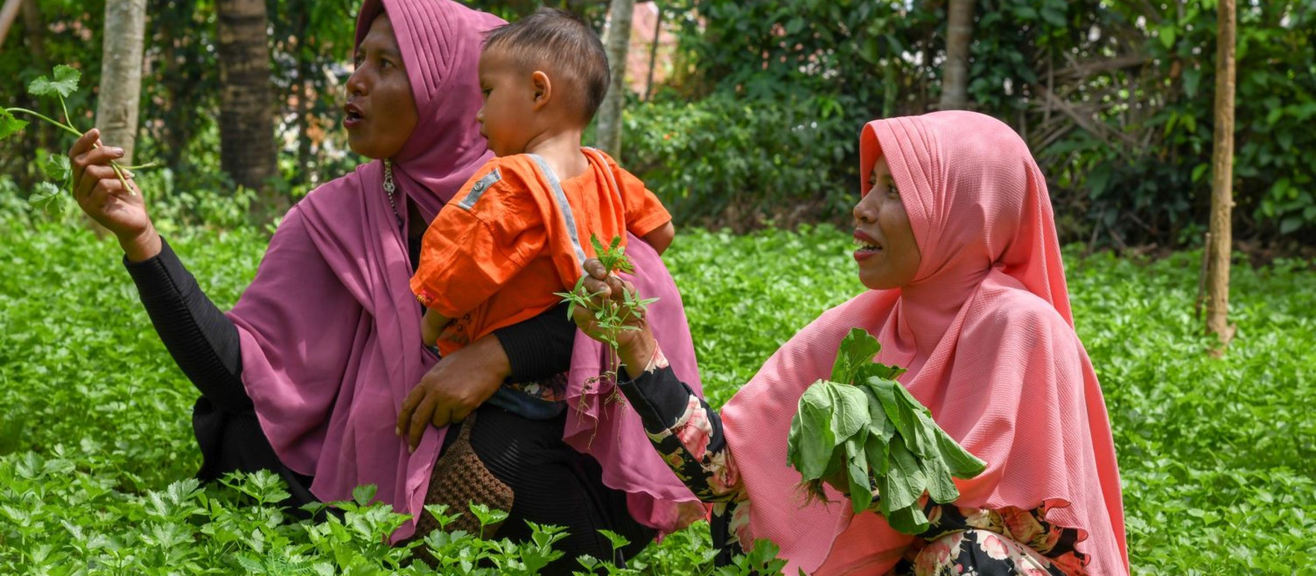 Women and child in a green field