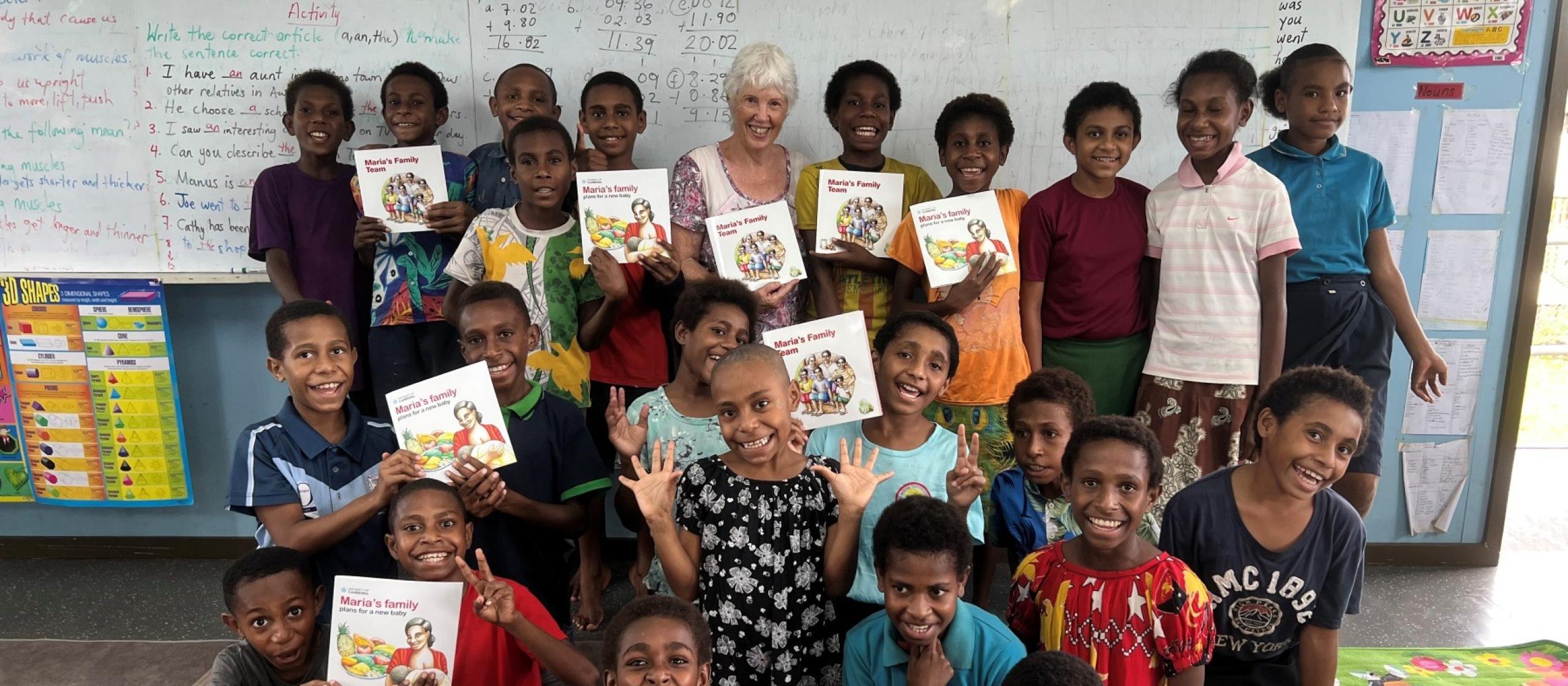 Children in a classroom holding picture books