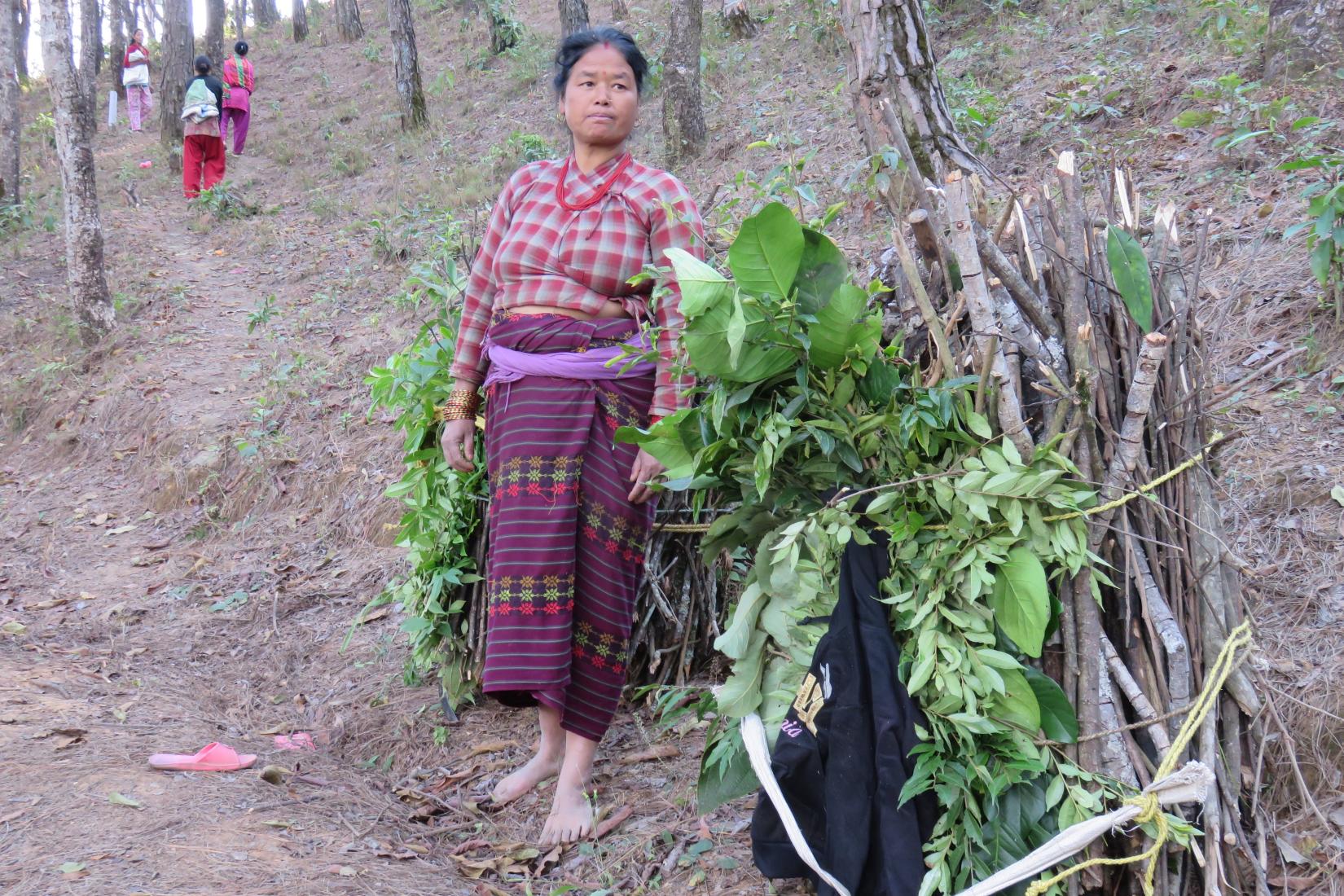 A woman stands next to a tree