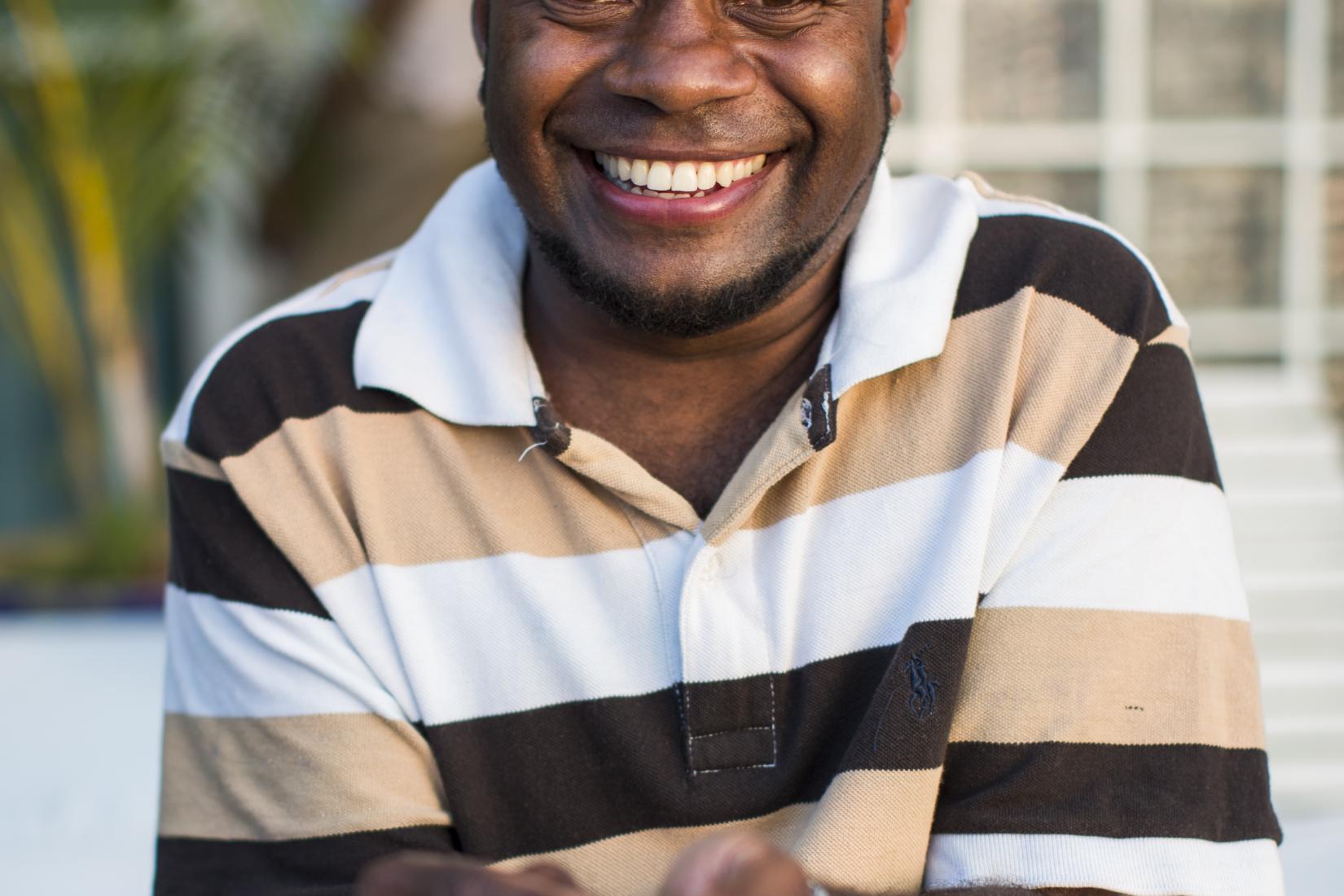 A man holds cocoa beans