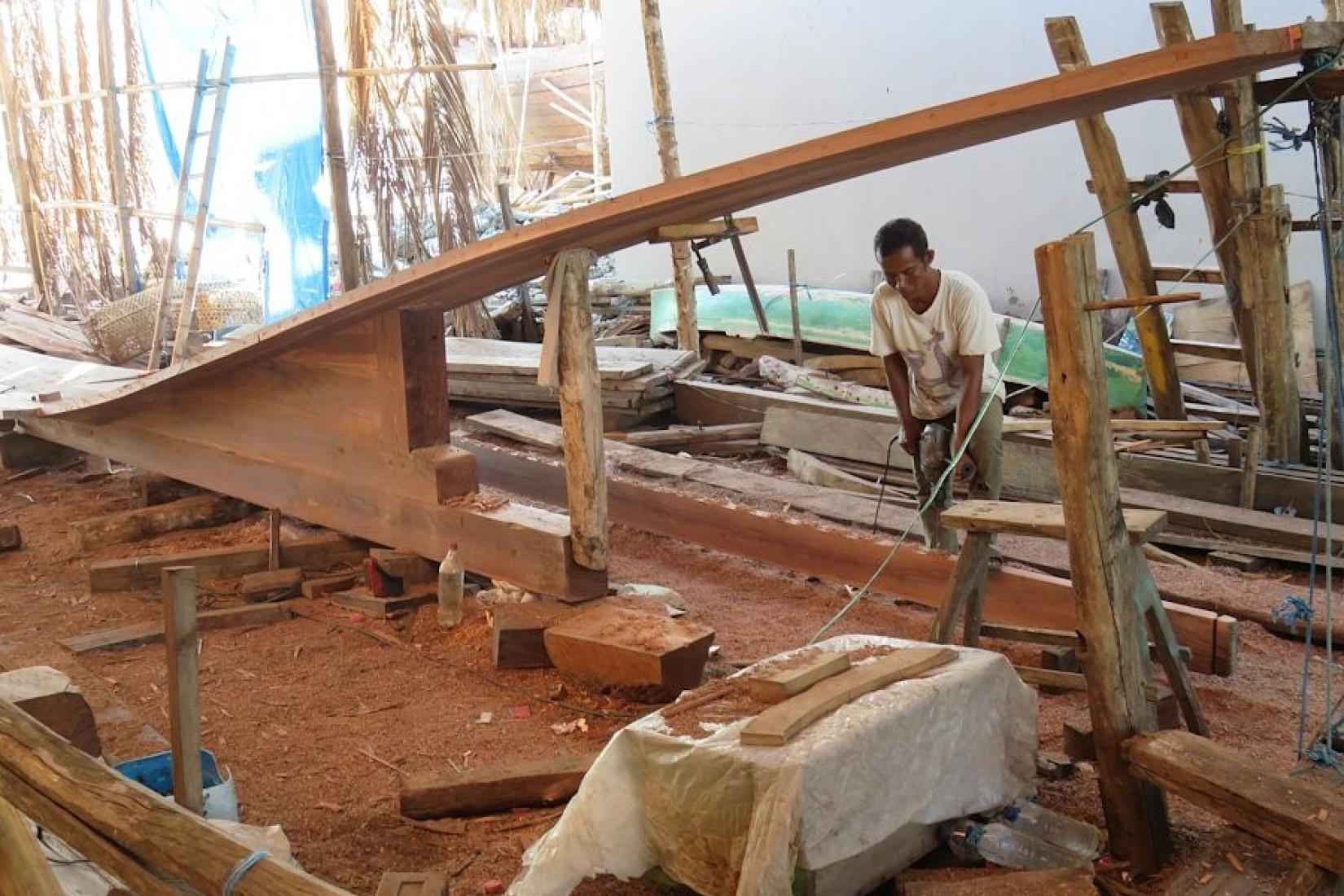 A man works in a wood workshop