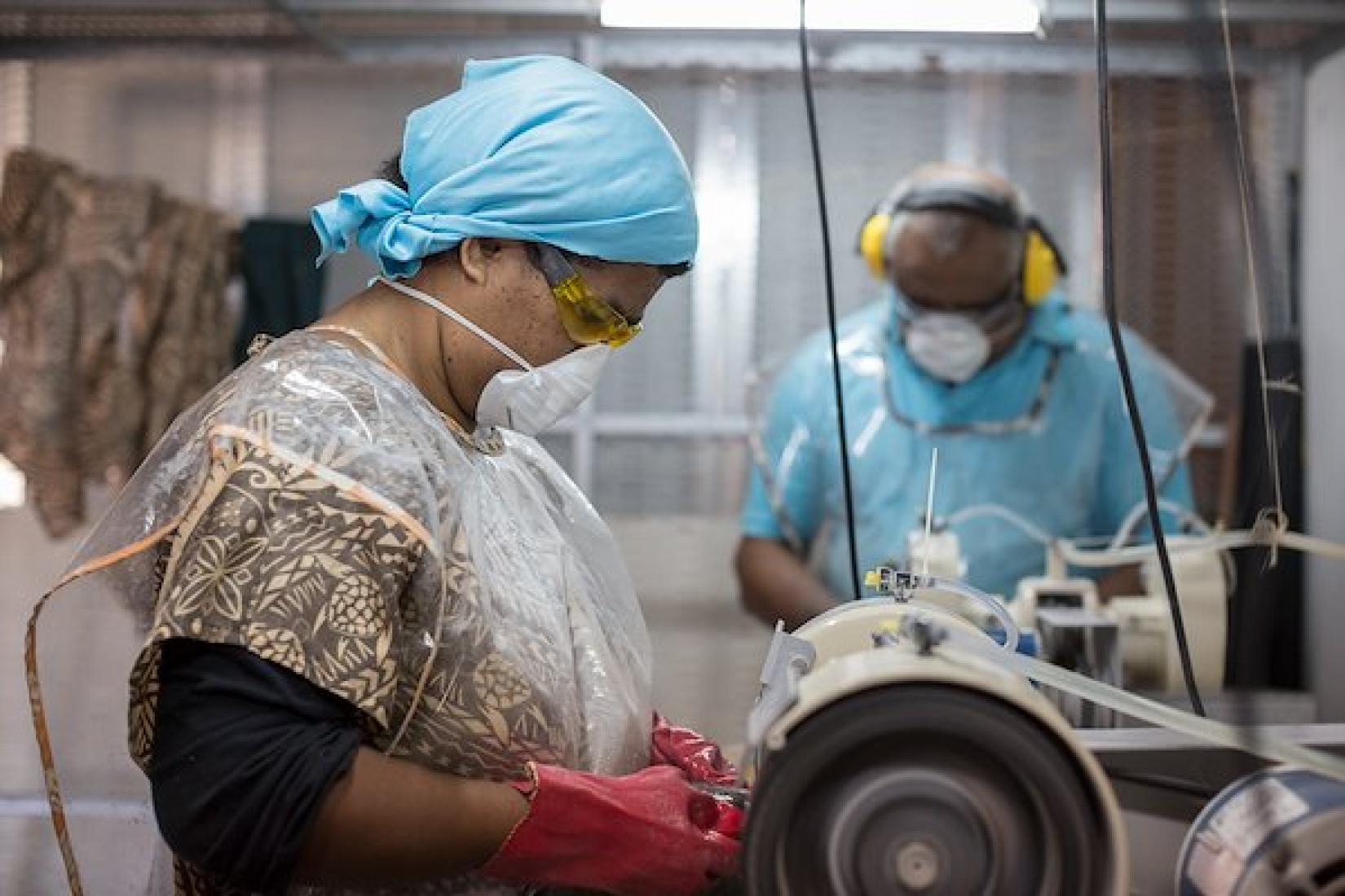 Sisilia Tuinasalia uses a sanding machine to buff a Mother of Pearl shell.  The MoP project has been funded by ACIAR's PARDI project in Fiji. Image: ACIAR /Conor Ashleigh