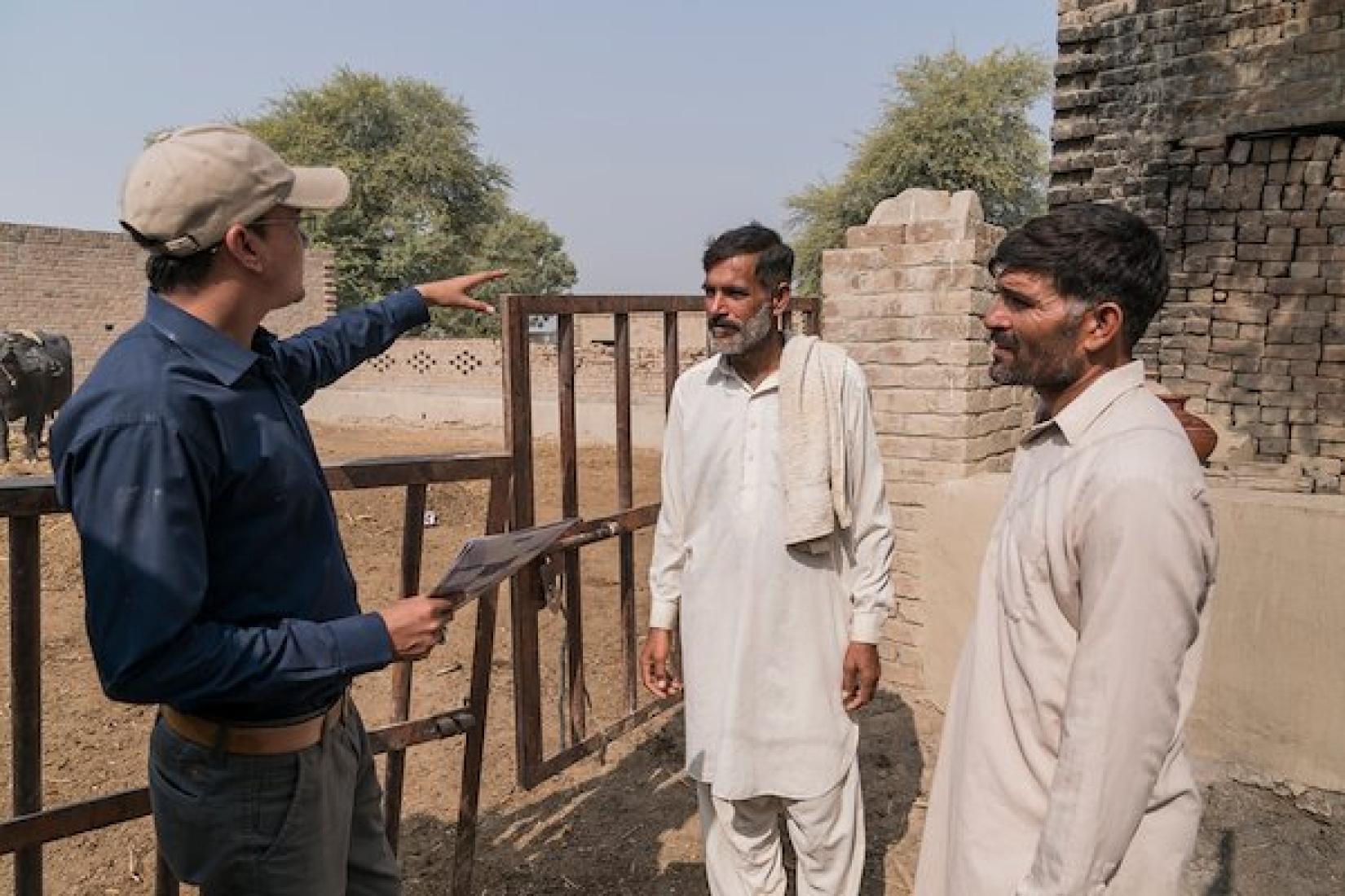 Khizer Hayat Punjab Province area adviser for the ASLP project talks to Allahdad (Centre) and his brother, both lead farmers from 96D village in rural Punjab Province. Image: ACIAR/Conor Ashleigh