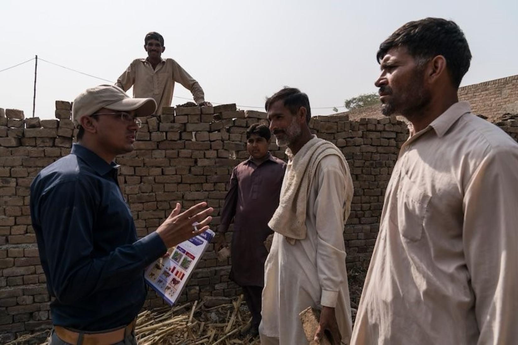 Khizer Hayat Punjab Province area adviser for the ASLP project talks to Allahdad (Centre) and his brother, both lead farmers from 96D village in rural Punjab Province. Image: ACIAR/Conor Ashleigh