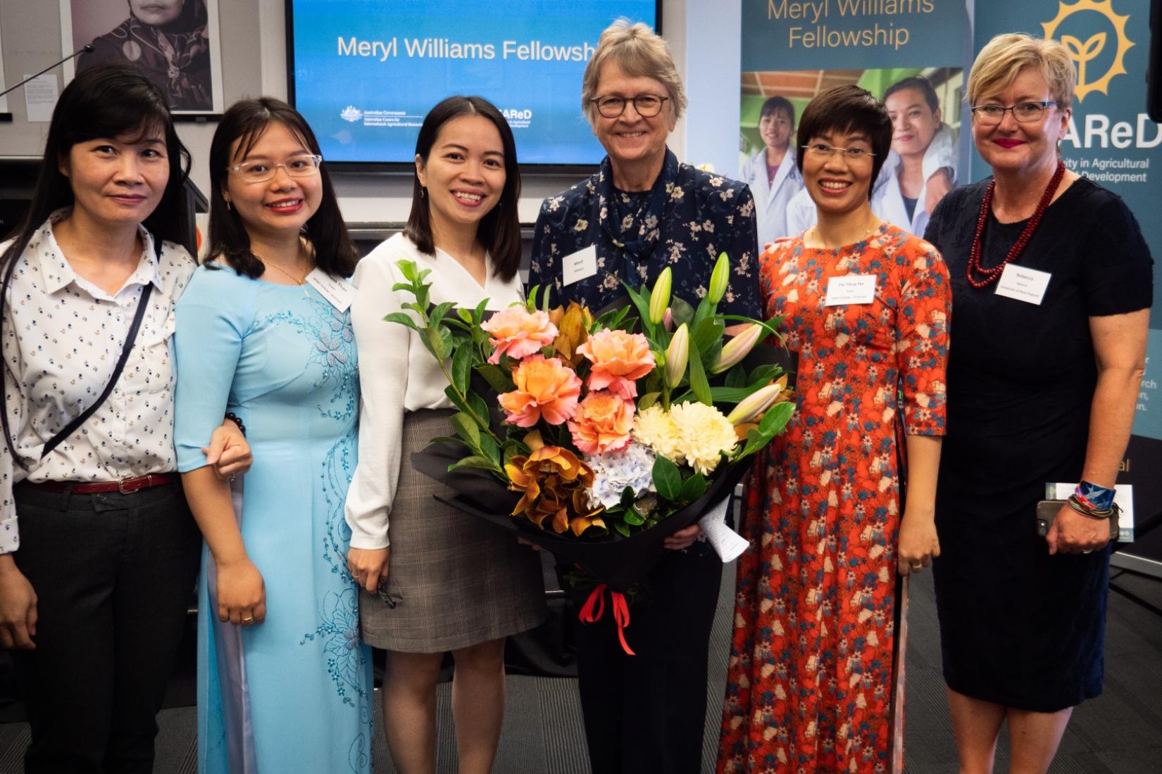 Group of women with bouquet of flowers