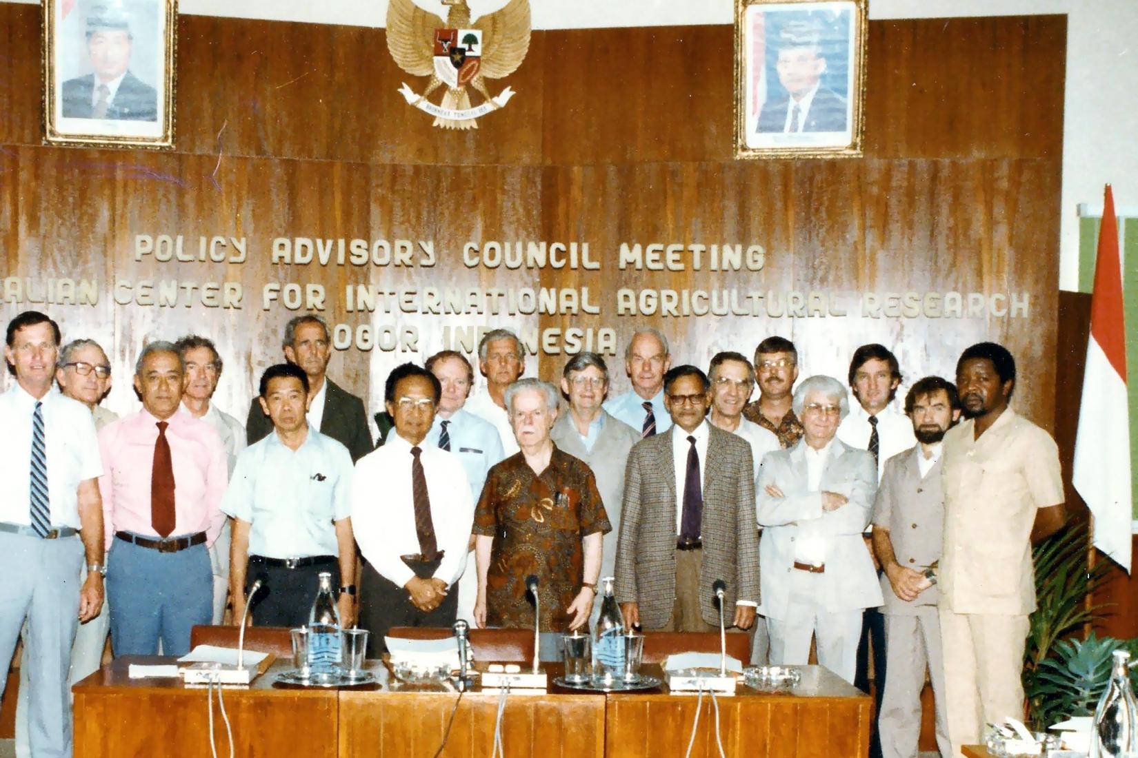 Group of people standing behind a desk