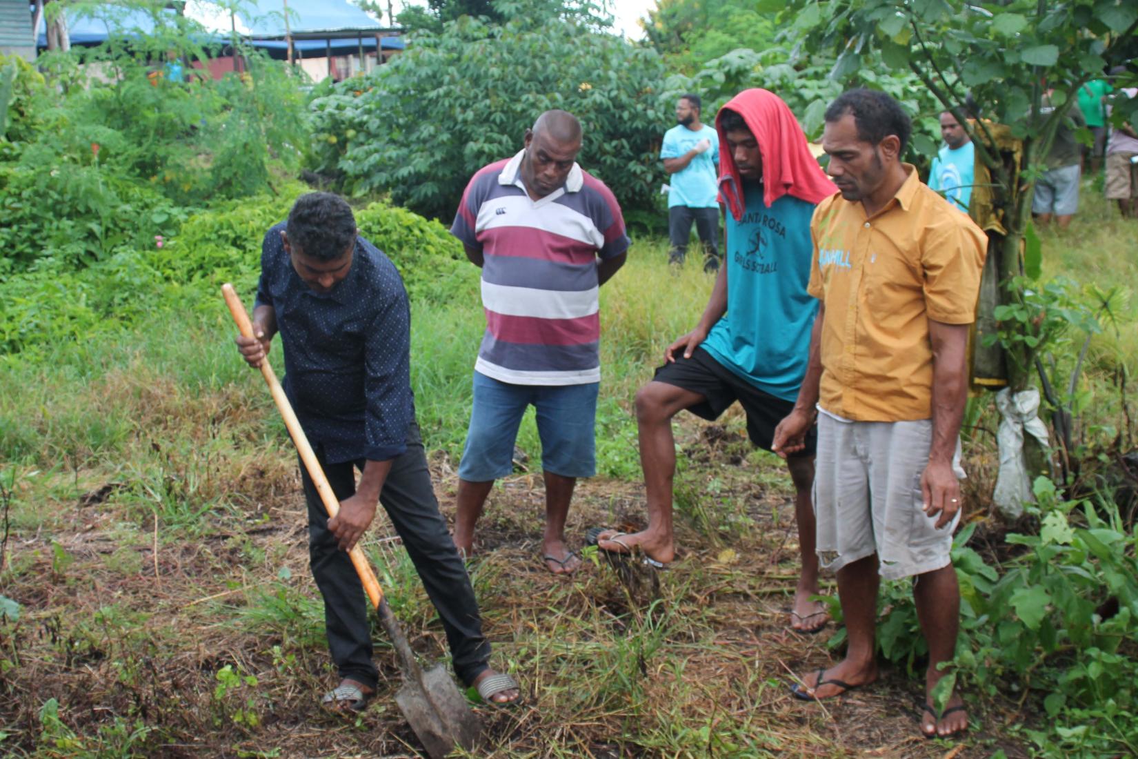 Dr Rohit lal takes farmers through a practical on how to determine soil health