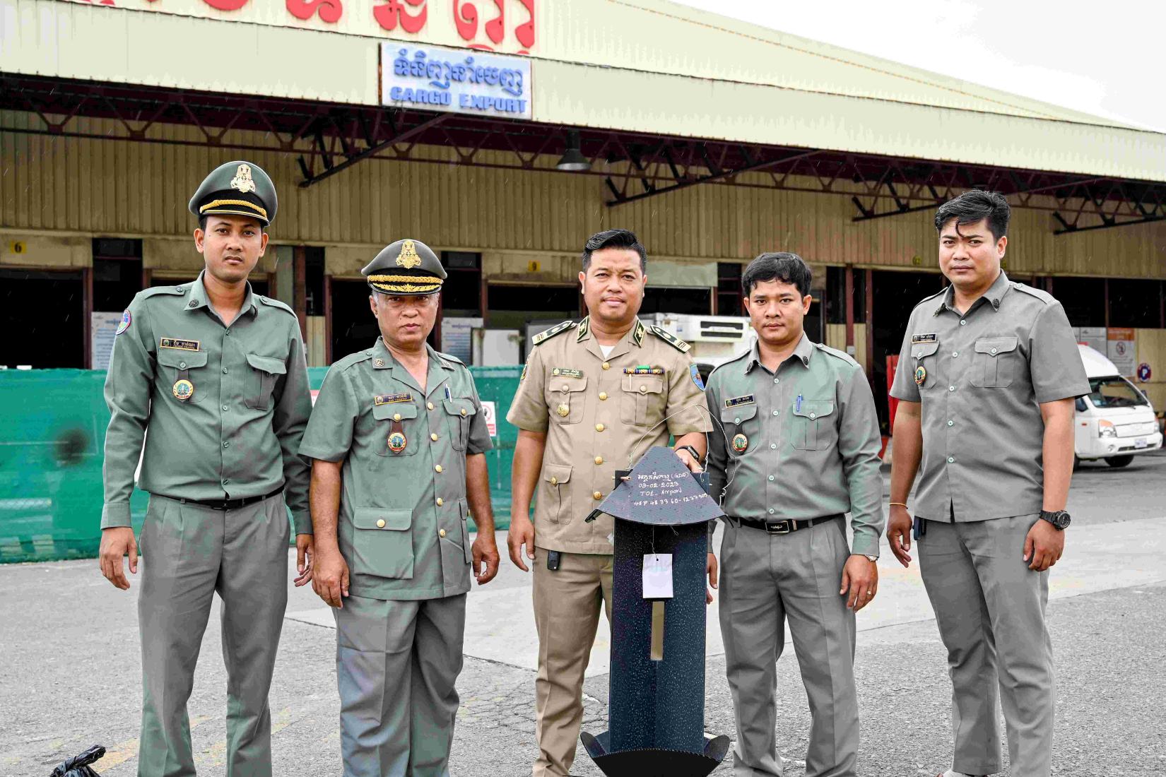 A research team from Cambodia with pest traps in front of export cargo at the Phnom Penh International Airport.