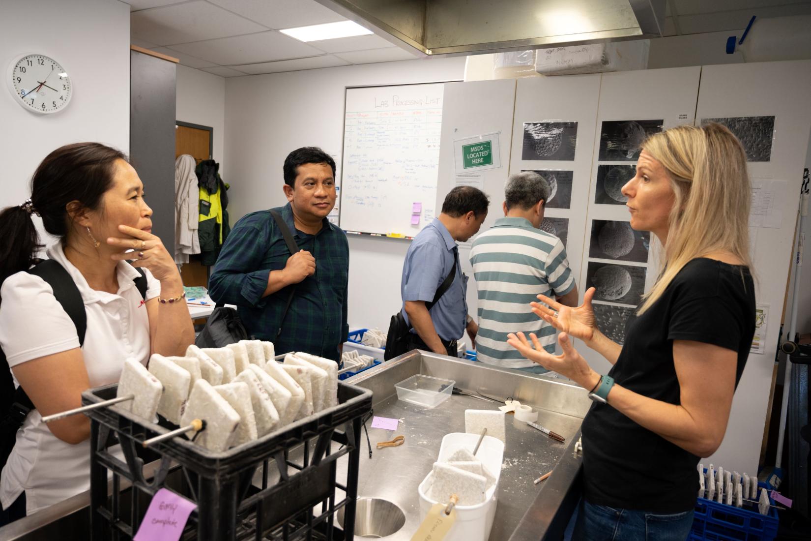 Researchers in discussion and inspeciting a lab