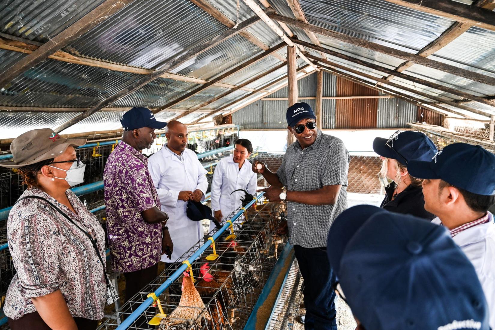 Man talking to a group of people in a hatchery
