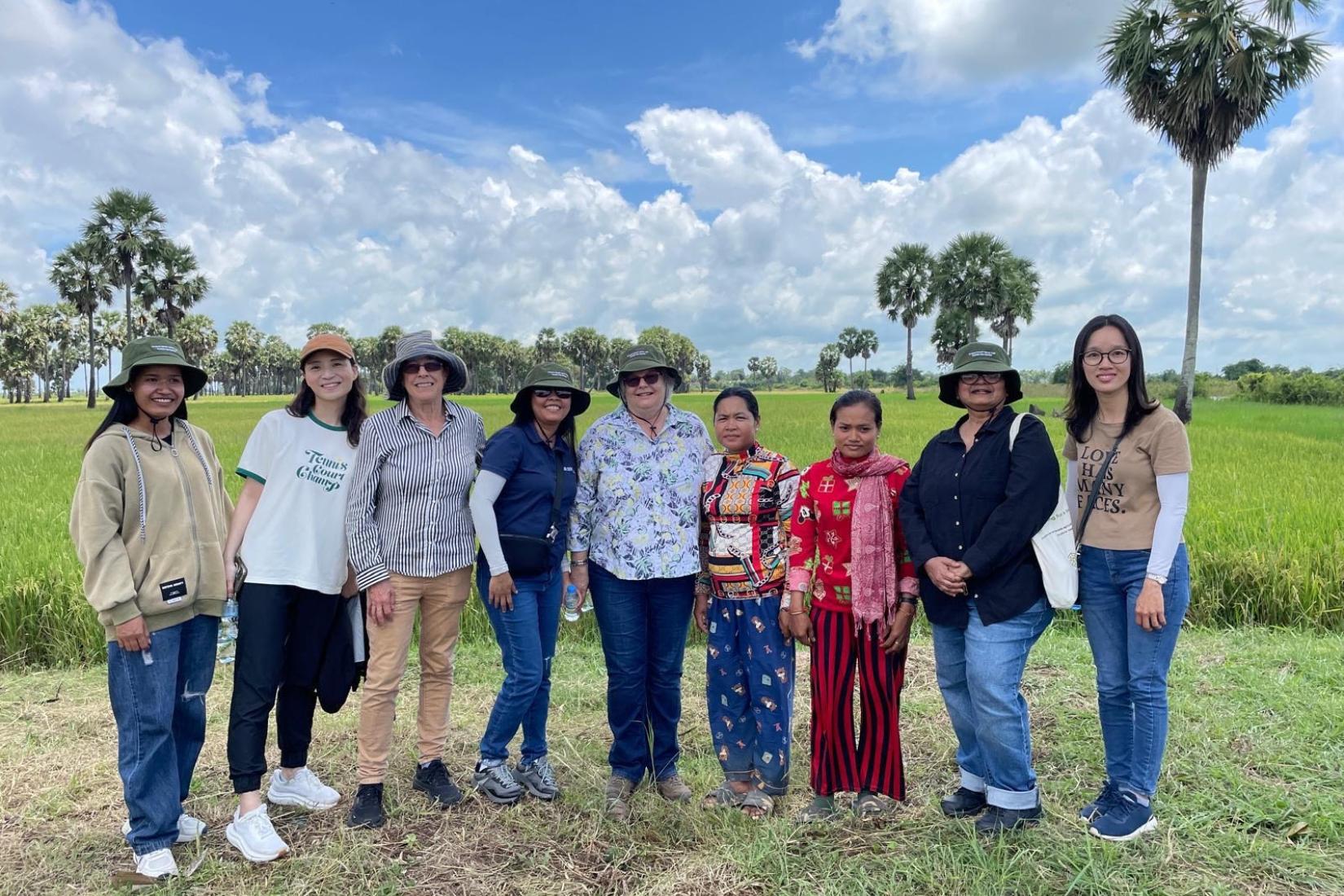 Group of women standing in a row in a field