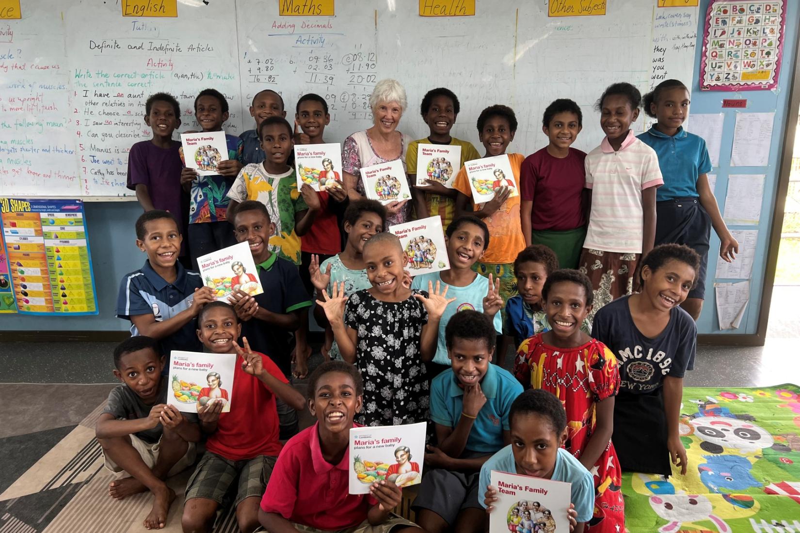 Group of children holding books up to the camera