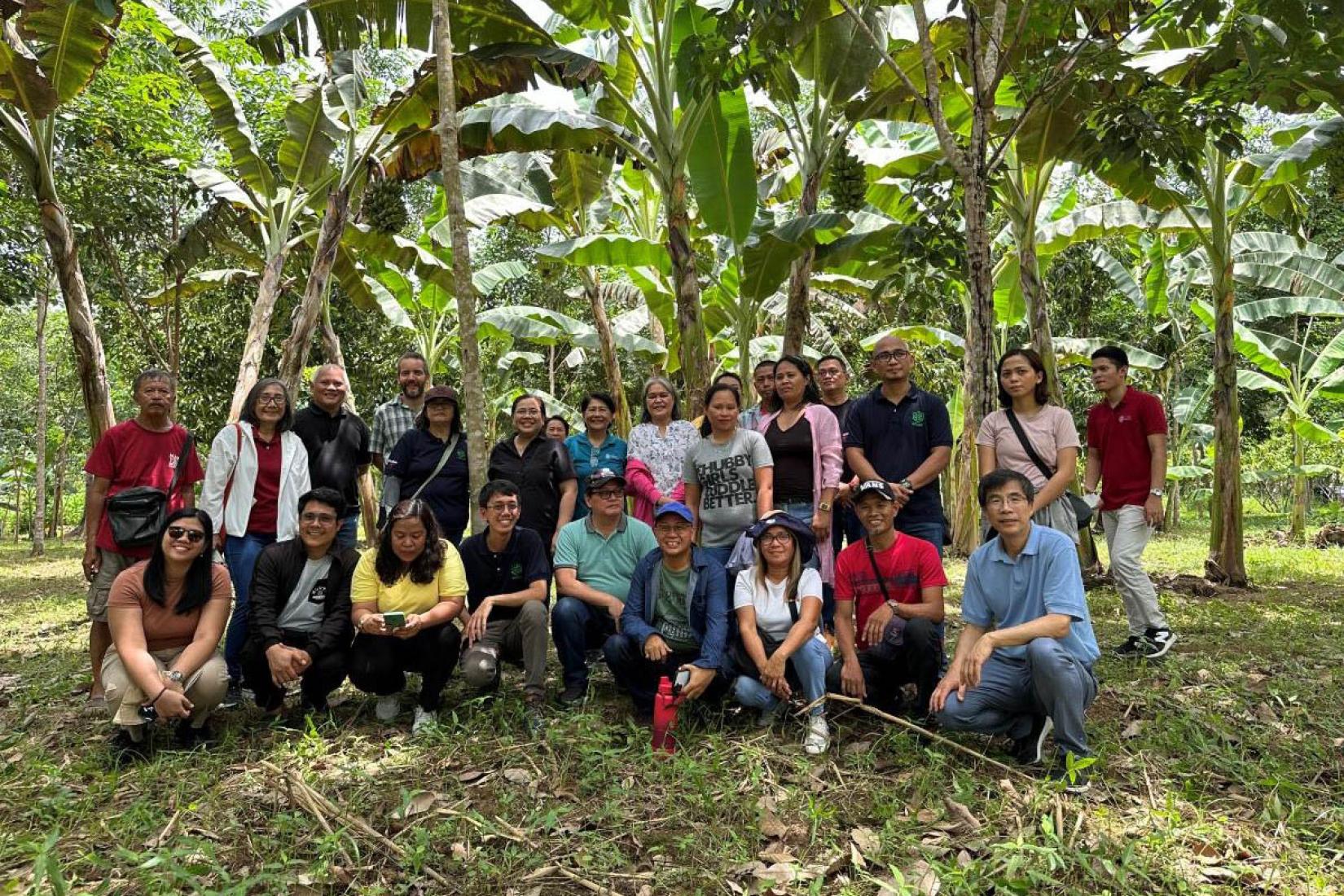 Group of people standing in front of trees