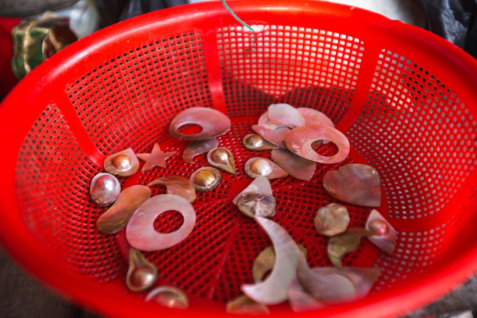 Pearl handicrafts in a red bowl