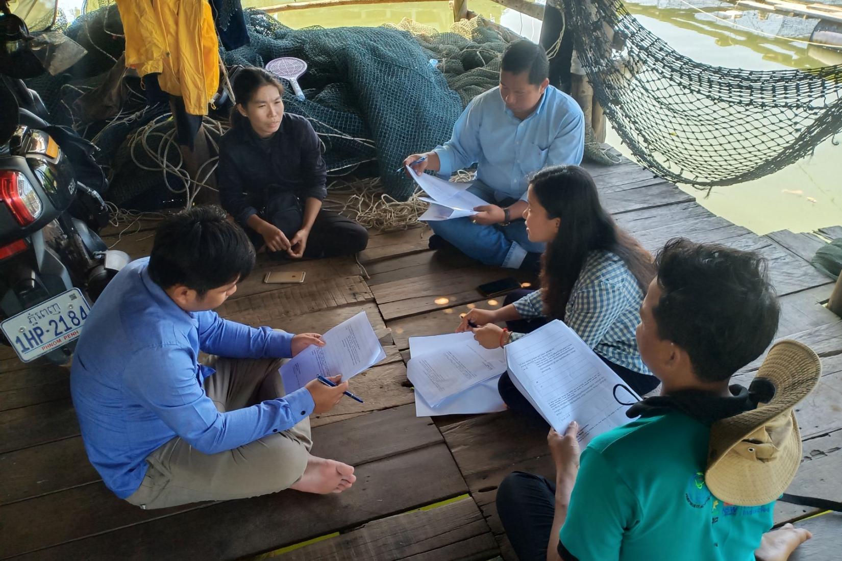 Group of people sitting on the ground in a circle