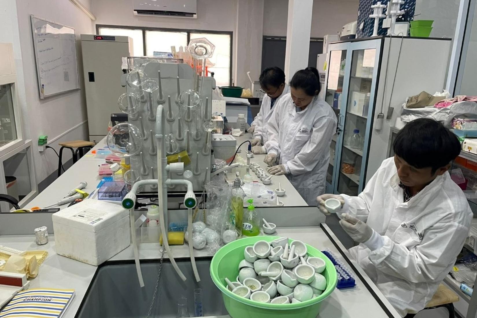 People in white coats working together in a scientific lab