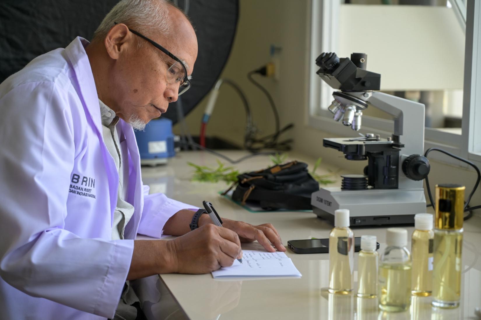 Researcher records observations in the laboratory.