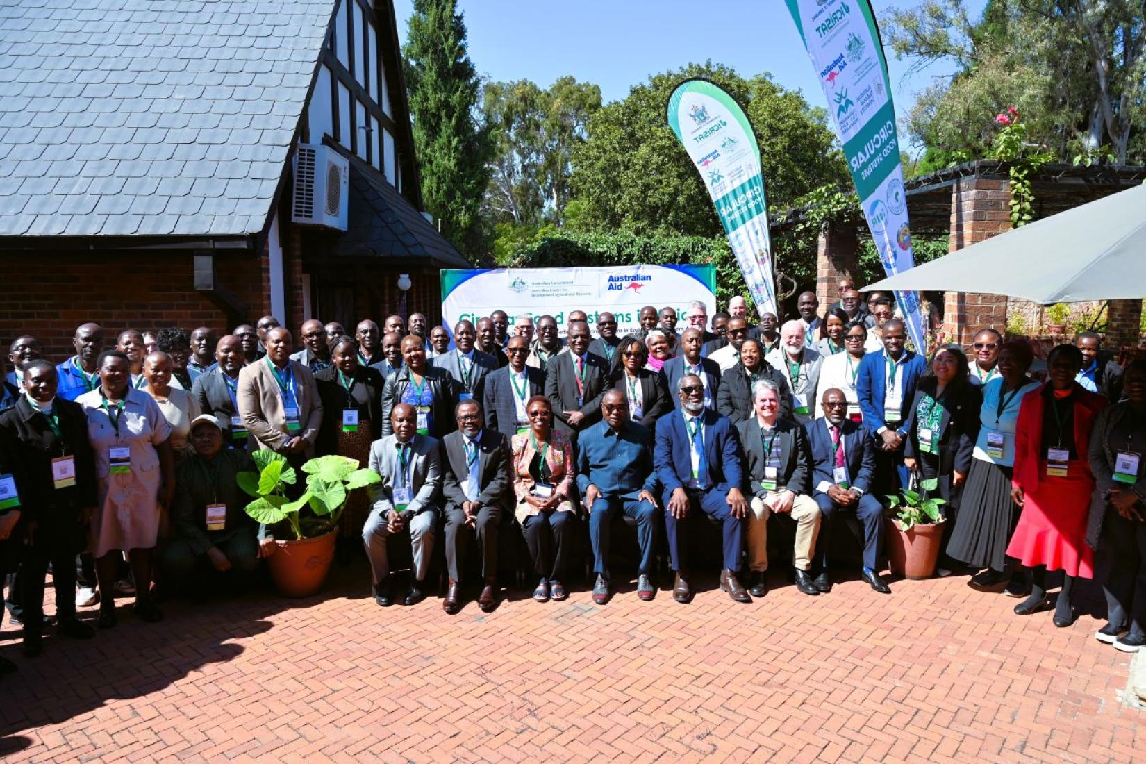 Large group of people posing for a photo at an agricultural event.