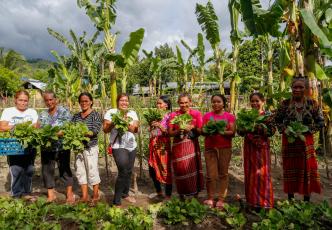 Women show the vegetables they harvest from their community garden in Paraiso village in Koronadal City in the Southern Philippine Province of South Cotabato, Mindanao