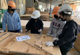 Students making adjustments to the bed design based on comments received from the faculty advisor.