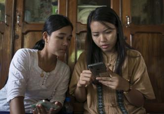 Two women looking at mobile device