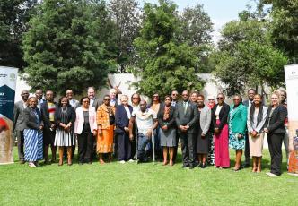 Group photo of event participants standing on a lawn