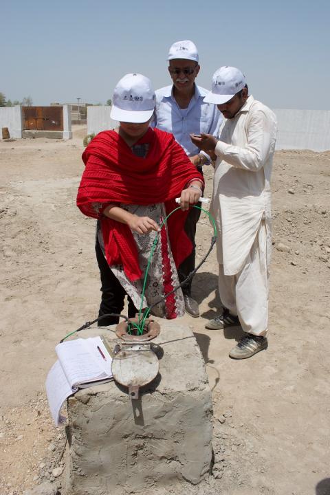 group of workers checking a well 