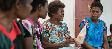 Local women farmers sit in discussion