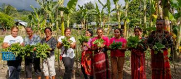  Women show the vegetables they harvest from their community garden in Paraiso village in Koronadal City in the Southern Philippine Province of South Cotabato, Mindanao