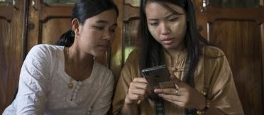 Two women looking at mobile device