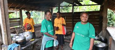 Village community educators smiling at the camera