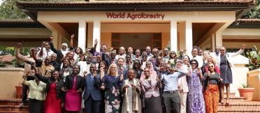 Group of participants celebrating outside the World Agroforestry building
