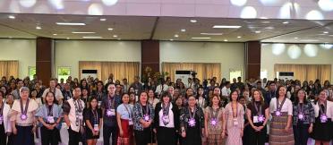 Large group participant photo in a conference hall