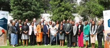 Group photo of event participants standing on a lawn