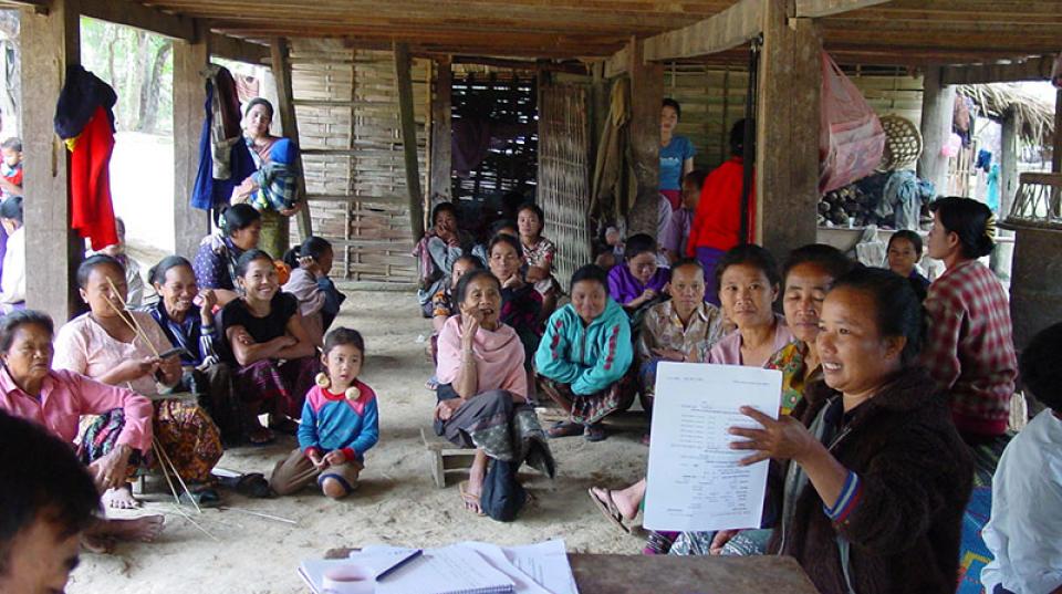 A group of women having a meeting under a wooden awning