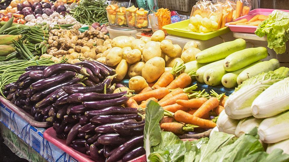 a variety of vegetables on a stand