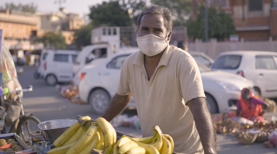 a man wearing a white face mask outdoors