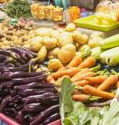 a variety of vegetables on a stand