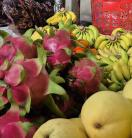 A close up of dragon fruit, bananas and mangoes