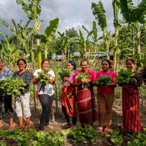 Women show the vegetables they harvest from their community garden in Paraiso village in Koronadal City in the Southern Philippine Province of South Cotabato, Mindanao