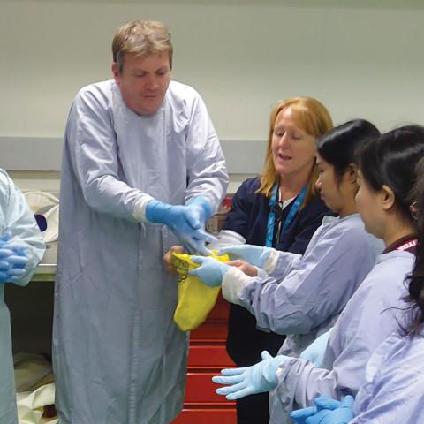 people putting on gloves to prevent spreading diseases