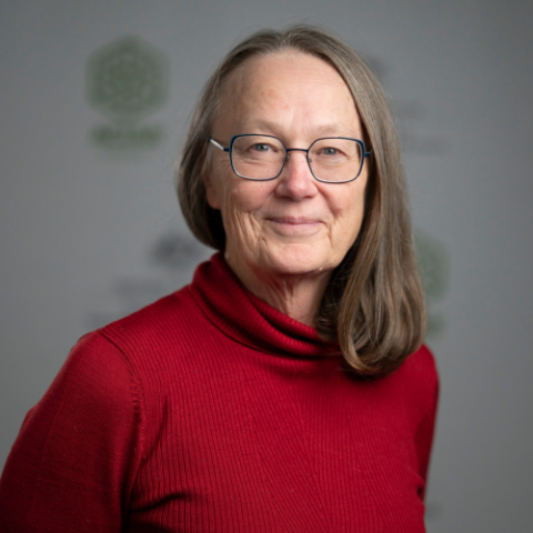 Woman in red jumper and glasses