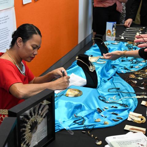 Women at a market stall with handicrafts