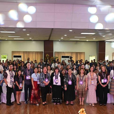 Large group participant photo in a conference hall