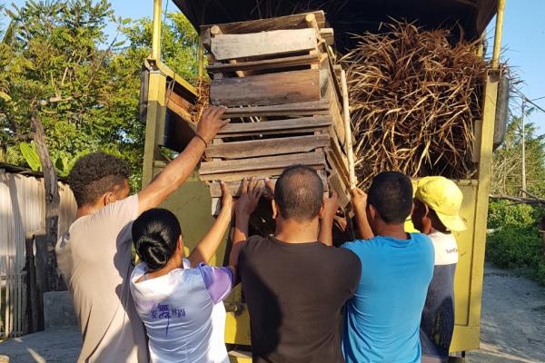 a group of people loading a truck