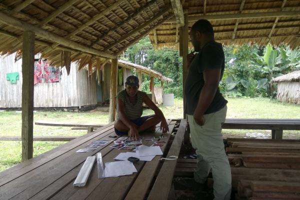 Daykin Harohau, JA fellow, interviews a tilapia farmer in Solomon Islands. Credit: Daykin Harohau