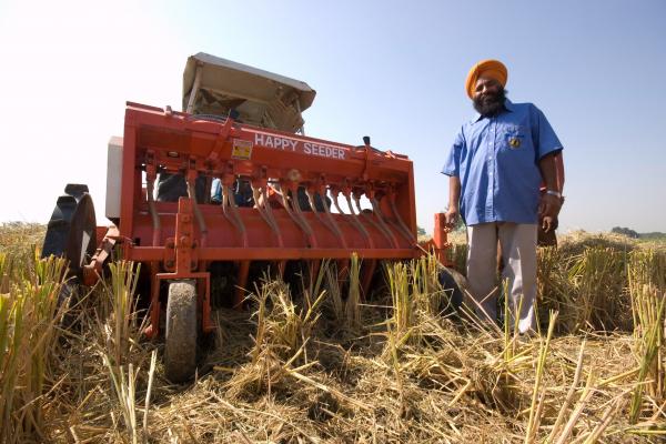 A local farmer in northern India with his Happy Seeder in the field.