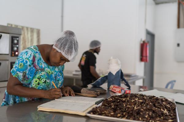 Helen Ronnie makes oil from canarium seeds. Helen is an assistant inside the canarium nut factor on the NARI Kerevat research station in East New Britain Province, Papua New Guinea. Image: ACIAR/Conor Ashleigh